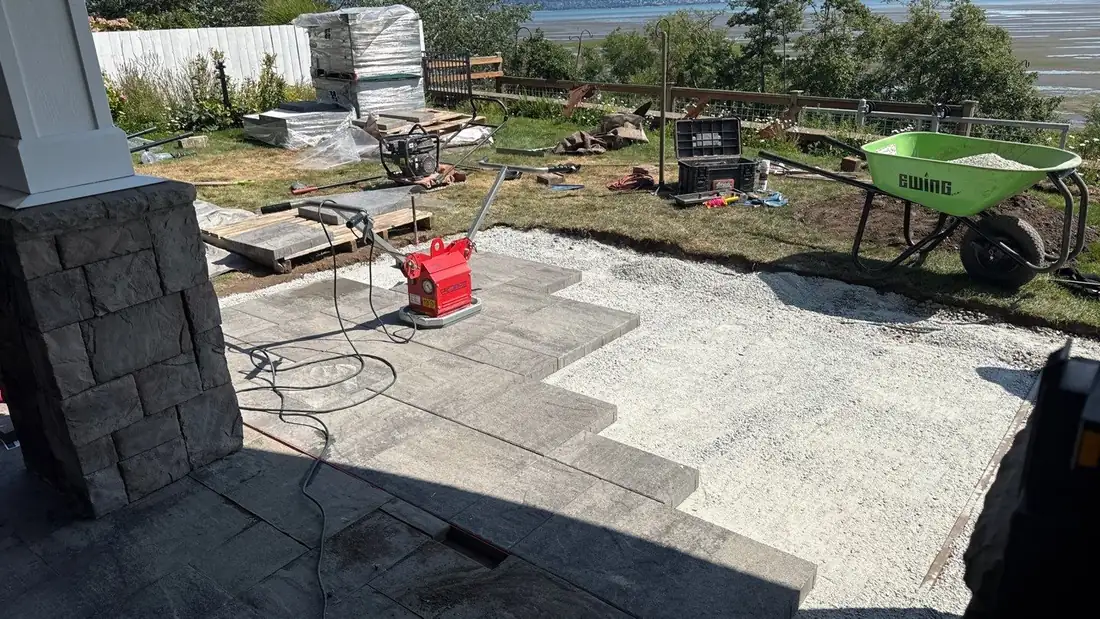 A finished paver patio beside a lawn