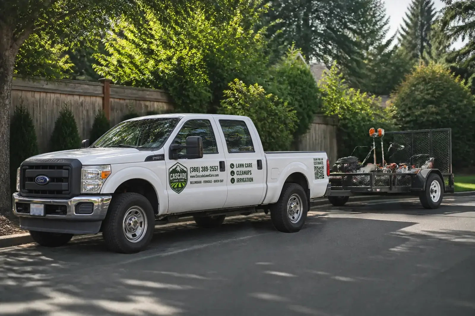 The Cascade Lawn Care truck and equipment trailer on a Bellingham street